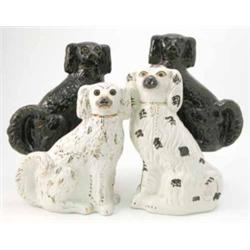 A pair of 19th century Staffordshire chimney dogs, with dark brown glaze and two similar cream gl...