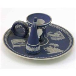 A Wedgwood blue jasper chamberstick and extinguisher, applied with classical reliefs in typical s...