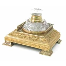 An Edwardian cut glass inkwell, on a foliate decorated and galleried cast brass stand 9.5"...