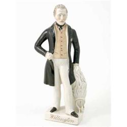 A Victorian Staffordshire pottery figure, "Wellington", standing, wearing three-quarter length bl...