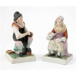 A pair of Victorian Staffordshire figures, seated cobbler, wife with jug, on square bases, 6.25in...