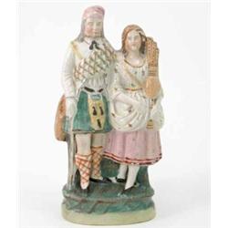 A Victorian Staffordshire pottery highland group, bearded male and female companion with pipes, o...