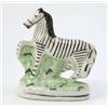 Image 1 : A Victorian Staffordshire model of a zebra, prancing pose, on oval base, 6.25in....