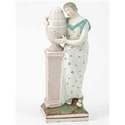 A late 18th century Staffordshire figure, Charlotte mourning, classical lady beside urn, on squar...