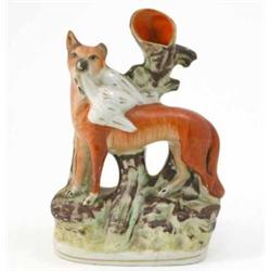 A Victorian Staffordshire spill vase group, fox and bird of prey, on moulded base, 9.25in....