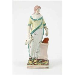 A late 18th century Staffordshire pottery figure of Hygea, serpent coiled around her left forearm...