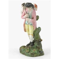 An early 19th century Staffordshire figure, "The Lost Sheep", shepherd carrying sheep on shoulder...