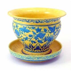 A Minton yellow-glazed jardiniere on stand, with blue-glazed and incised insects and foliage, 12i...