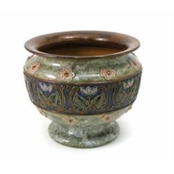 A large Royal Doulton glazed stoneware jardiniere, moulded with a stylised floral border and rose...