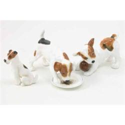 Three Royal Doulton bone china dog models, comprising a Jack Russell licking from a plate, HN 115...