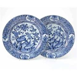 A pair of Chien Lung blue and white plates, decorated with birds, rocks and flowers 14.25ins...