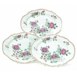 A set of three Chien Lung famille rose dessert plates, decorated with flowers within a spearhead...
