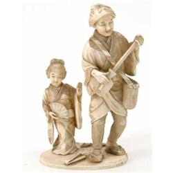 A Japanese carved ivory group of a musician and child dancer, 6.75ins...