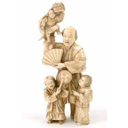 A Japanese carved walrus ivory group of an entertainer with three children 7ins...