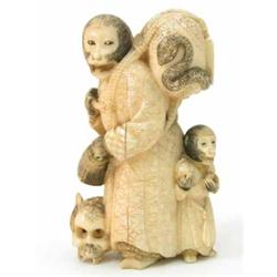 A Japanese marine ivory group of two monkeys carrying three skulls, signed 4ins...