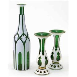 A pair of late 19th century Bohemian green glass vases, with gilded white overlay (7in.) and a si...