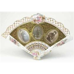 A 19th century French ceramic fan shaped photograph frame, decorated with moulded foliage and pie...