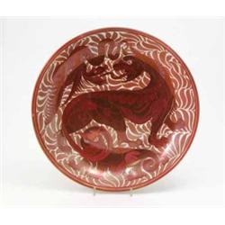 A William De Morgan lustre charger decorated by Charles Passenger, painted with grotesque beasts...