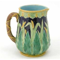 A Victorian majolica jug, moulded with wheat against a dark blue ground, pattern no. 1806, cracke...