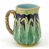 Image 1 : A Victorian majolica jug, moulded with wheat against a dark blue ground, pattern no. 1806, cracke...