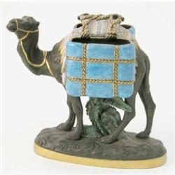 A George Jones 'Kumassie' majolica and black basalt camel, laden with two glazed, rope-bound bask...