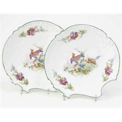 A pair of Royal Worcester dessert plates, asymmetrical with pierced borders, painted with exotic...
