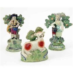 A pair of early Walton figures, gardener and female companion, scroll marks, 5.5ins and a model o...