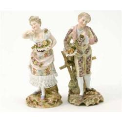 A pair of Rudolstadt Volkstedt figures, male with grapes and basket of fruit, female carrying bas...