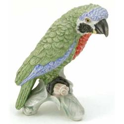 A Goebel bisque porcelain parrot, painted in green, blue and red, perched upon branch, impressed...