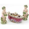 Image 1 : A pair of Continental porcelain figures of putti, in the style of Bow, each modelled with a flora...