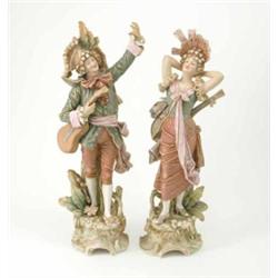 A pair of Royal Dux figures of musicians, on mound and scroll bases, 21ins...