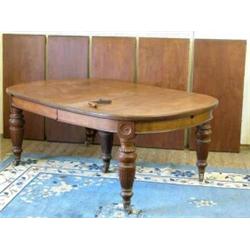 A large late Victorian mahogany extending dining table, with rounded ends and five extra leaves,...