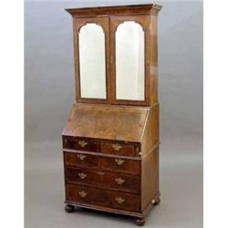 A George I design walnut bureau bookcase, with two mirrored doors, fitted interior and four short...
