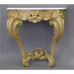 A mid 18th century giltwood console table, with later white marble top on a rococo base with scro...