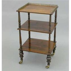 A Regency rosewood three tier whatnot, replaced gilt brass gallery and turned supports on toupie...