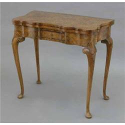 A George I design walnut and mahogany banded serpentine card table, with small central drawer on...