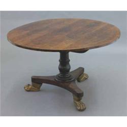 A Regency rosewood and string inlaid circular breakfast table, on turned stem and triform base fi...