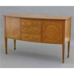 An Edwardian satinwood and string inlaid bow front sideboard, by Maple & Co, Paris, with three ce...