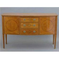 An Edwardian satinwood and string inlaid bow front sideboard, by Maple & Co, Paris, with three ce...