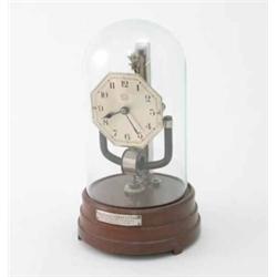 A Boulle junior electric timepiece, with silvered dial, glass dome and 1933 presentation inscript...