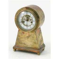 An American brass mantel clock, in escutcheon shaped case, with enamelled Arabic dial and visible...