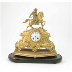 A Victorian gilt metal mantel clock, surmounted with a knight on horseback, 15ins...