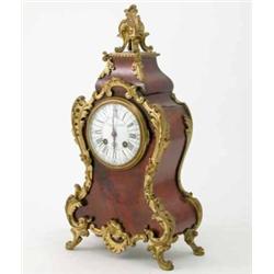 A French Louis XVI design ormolu mounted tortoiseshell mantel clock, with enamelled dial, retaile...