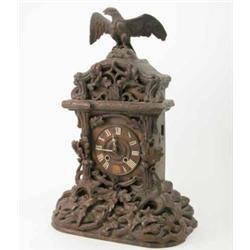 A Black Forest carved wood cuckoo mantel clock, surmounted with an eagle, 23ins...