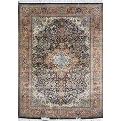 A modern Persian silk dark blue ground rug, woven central floral medallion within a pink and crea...