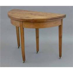 A George III fruitwood demi lune tea table, on square tapered legs, fitted brass castors, 3ft 4in...