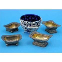 A Victorian plated sugar basket, with pierced foliate decoration and blue glass liner, and two pa...