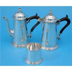 A pair of George VI silver cafe au lait pots, with ebony scroll handles, reeded and fluted decora...