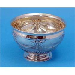 An Edwardian silver rose bowl, with demi-fluted decoration and repousse swags, maker Goldsmiths &...