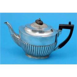 A Victorian silver teapot, of oval form with demi-fluted decoration, maker Charles Stuart Harris,...